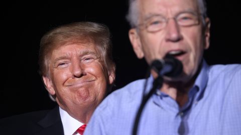 Former President Donald Trump smiles as Sen Chuck Grassley (R-IA)  speaks during a rally at the Iowa State Fairgrounds on October 09, 2021 in Des Moines, Iowa.