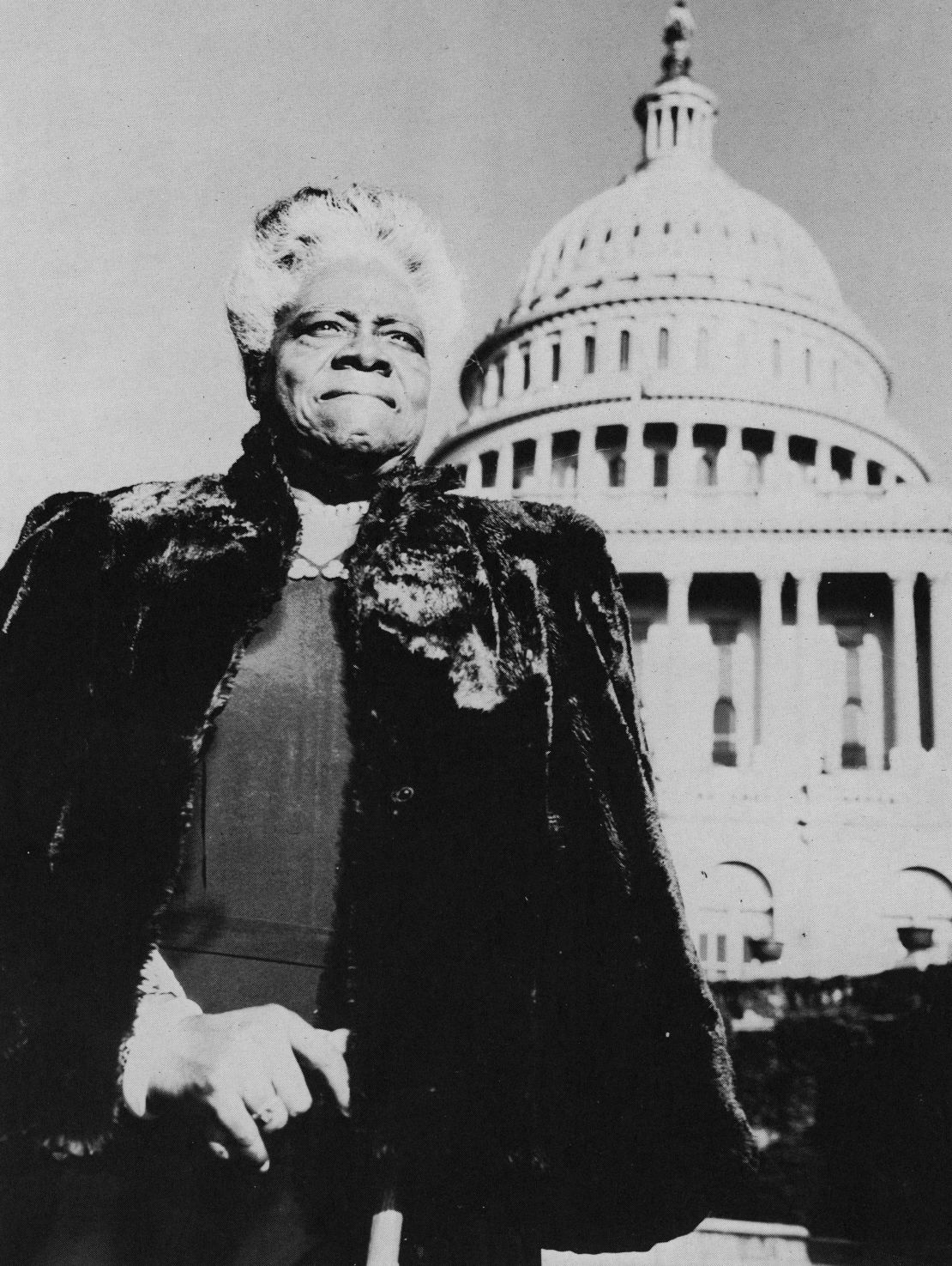 Mary McLeod Bethune stands with the U.S. Capitol in the background, circa 1950.