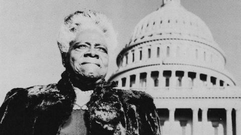 Mary McLeod Bethune stands with the U.S. Capitol in the background, circa 1950.
