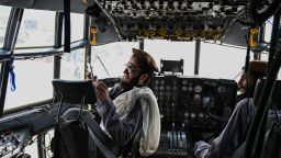 TOPSHOT - Taliban fighters sit in the cockpit of an Afghan Air Force aircraft at the airport in Kabul on August 31, 2021, after the US has pulled all its troops out of the country to end a brutal 20-year war -- one that started and ended with the hardline Islamist in power. (Photo by Wakil KOHSAR / AFP) (Photo by WAKIL KOHSAR/AFP via Getty Images)