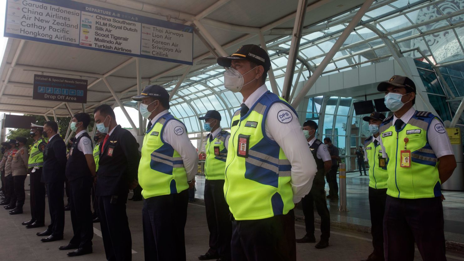 Airport security personnel line up during a briefing in preparation of the reopening of International Ngurah Rai Airport in Bali, Indonesia, Thursday, Oct. 14, 2021. The Indonesian resort island of Bali welcomed international travelers to its shops and white-sand beaches for the first time in more than a year Thursday - if they're vaccinated, test negative, hail from certain countries, quarantine and heed restrictions in public. (AP Photo/Firdia Lisnawati)