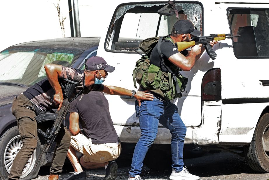 Fighters from the Hezbollah and Amal movements take aim during the clashes.