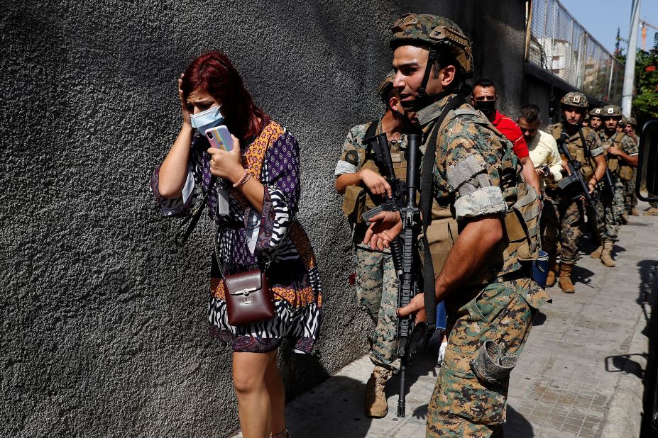 Lebanese soldiers protect teachers as they flee their school.