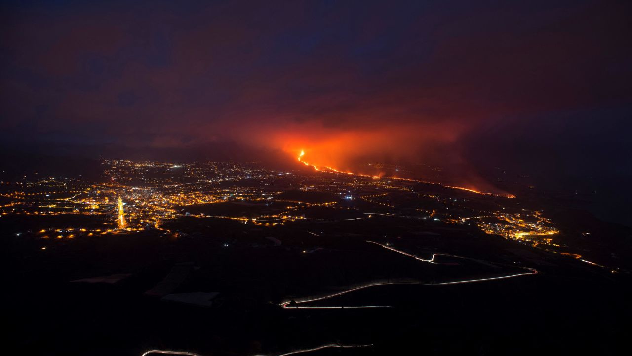 The Cumbre Vieja volcano, pictured from Tijarafe, spews lava, ash and smoke, on La Palma, at night on October 10.