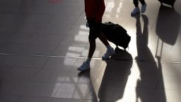 Two young men walk through Terminal 1 with their suitcases on June 25 2021 in Hamburg, Germany. 