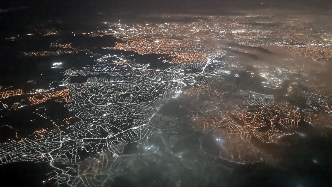 Swoop in at night over the glowing cityscape of São Paulo. 