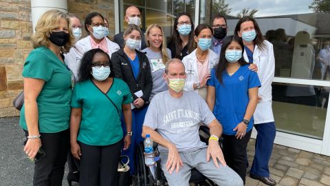 Robby Walker, his wife Susan (in gray shirt) and members of Saint Francis Hospital's ECMO team gather Wednesday to celebrate Walker's release from rehabilitation at Gaylord Specialty Healthcare. Angela Sakal (far right) was Walker's chief perfusionist at Saint Francis.