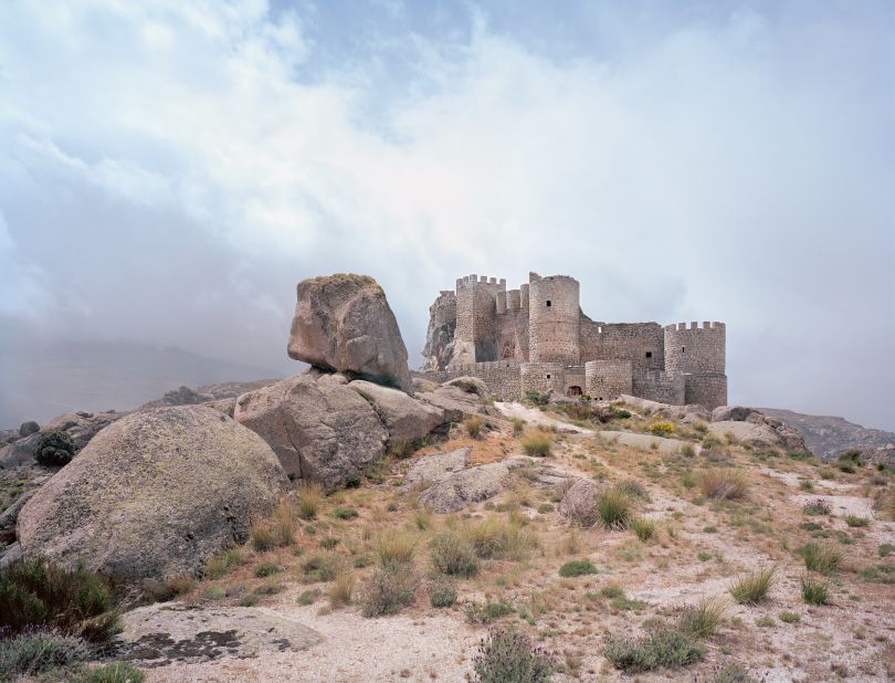 Castle Manqueospese appears to melt into the granite landscape in Spain.