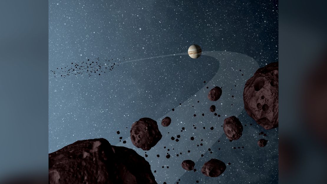 New results from NASA's Wide-field Infrared Explorer, or WISE, reveal that the Jovian Trojans - asteroids that lap the sun in the same orbit as Jupiter - are uniformly dark with a hint of burgundy color, and have matte surfaces that reflect little sunlight. The results are illustrated in this artist's concept, showing both the leading and trailing packs of Trojans in orbit with Jupiter. Observations from WISE also confirmed the previous suspicion that there are more asteroids in the leading pack of Trojans (seen in the distance) than the trailing bunch. The results are helping astronomers fill in missing pieces of the ongoing Jupiter Trojan puzzle: how and when did these asteroids form? The data for this research come from the asteroid-hunting portion of the WISE survey, called NEOWISE.