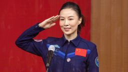 Chinese astronaut Wang Yaping, member of the second crew for China's new space station, salutes as she attends a briefing the day before the launch, at the Jiuquan Satellite Launch Center in the Gobi desert, northwest China on October 14, 2021.