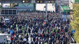 This photo obtained from Italian news agency Ansa shows dockers and port workers gathering for a protest in the port of Trieste on October 15, 2021 as new Green Pass requirements for workers come into force.
