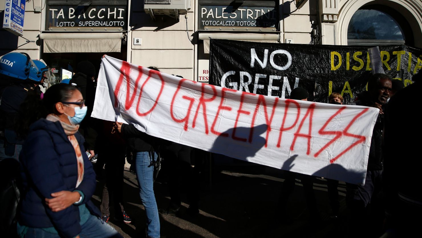 People hold a banner reading "No Green Pass" during a protest in Rome on Friday October 15.