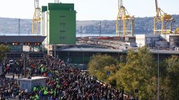 People participate in a protest against the implementation of the COVID-19 health pass, the Green Pass, in the workplace as they gather outside the entrance of the major port of Trieste, Italy, Oct. 15, 2021. 