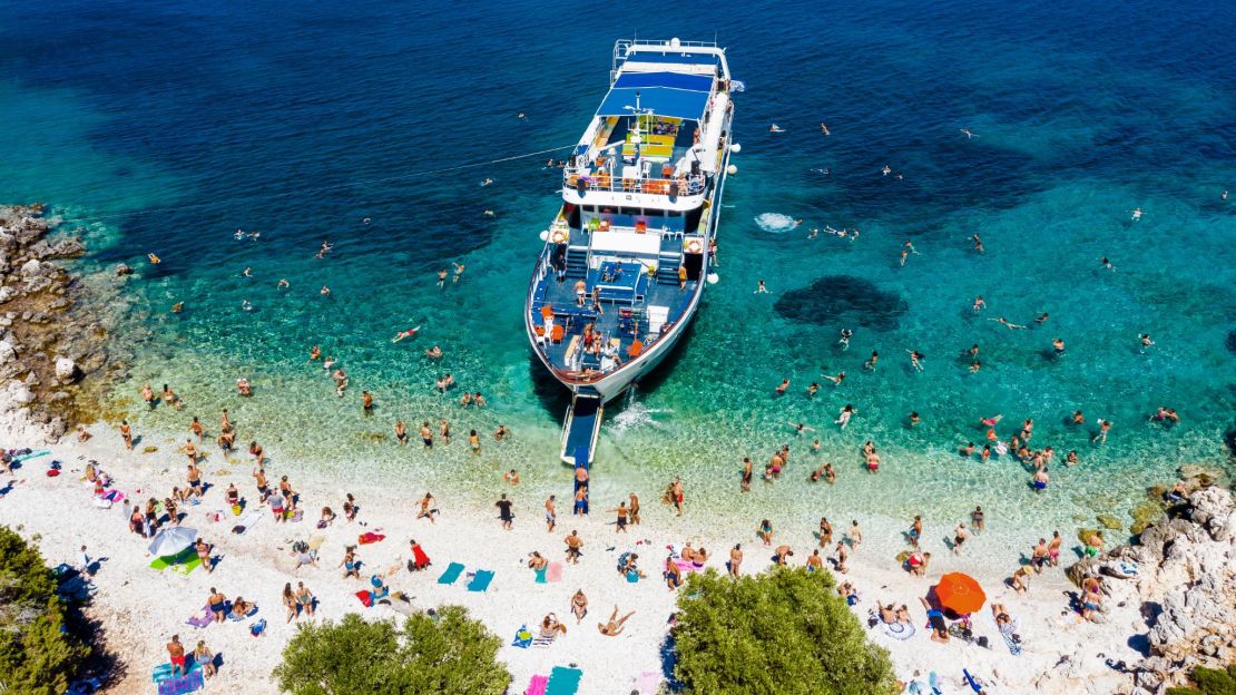 A busy private beach in Ithaca, Greece, where the water is fine for open-water swimming.