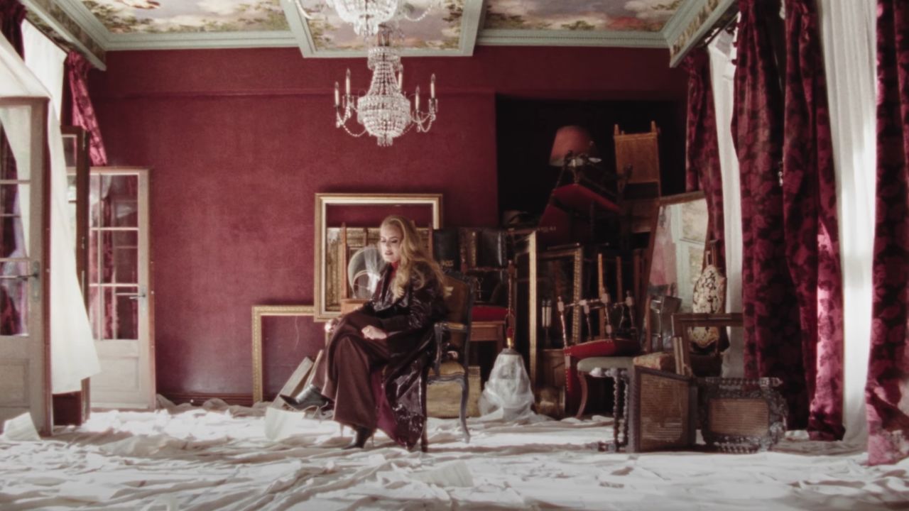 A scene from Adele's music video for "Easy on Me" is shown. 