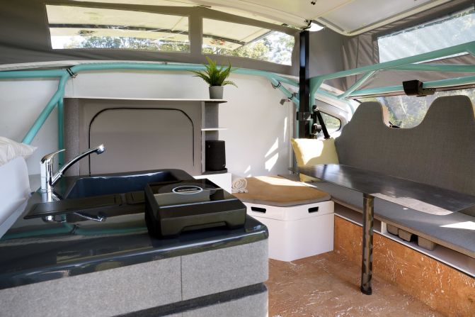 The interior of the campervan featured a double bed, couch, kitchen area and bathroom with a sink, shower and toilet. When the extendable roof is lifted, occupants can shower, make a cup of coffee and watch TV using the energy of the sun alone. 