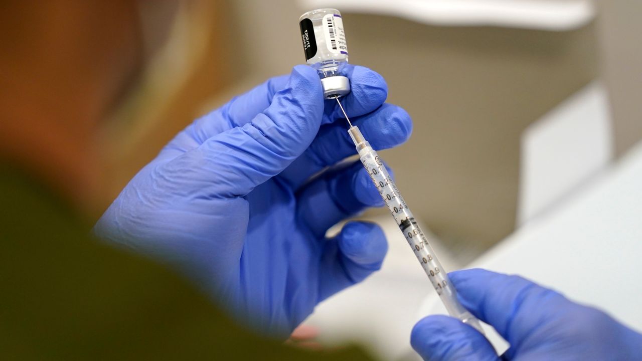 A health care worker fills a syringe with the Pfizer Covid-19 vaccine at Jackson Memorial Hospital on October 5, 2021, in Miami.  