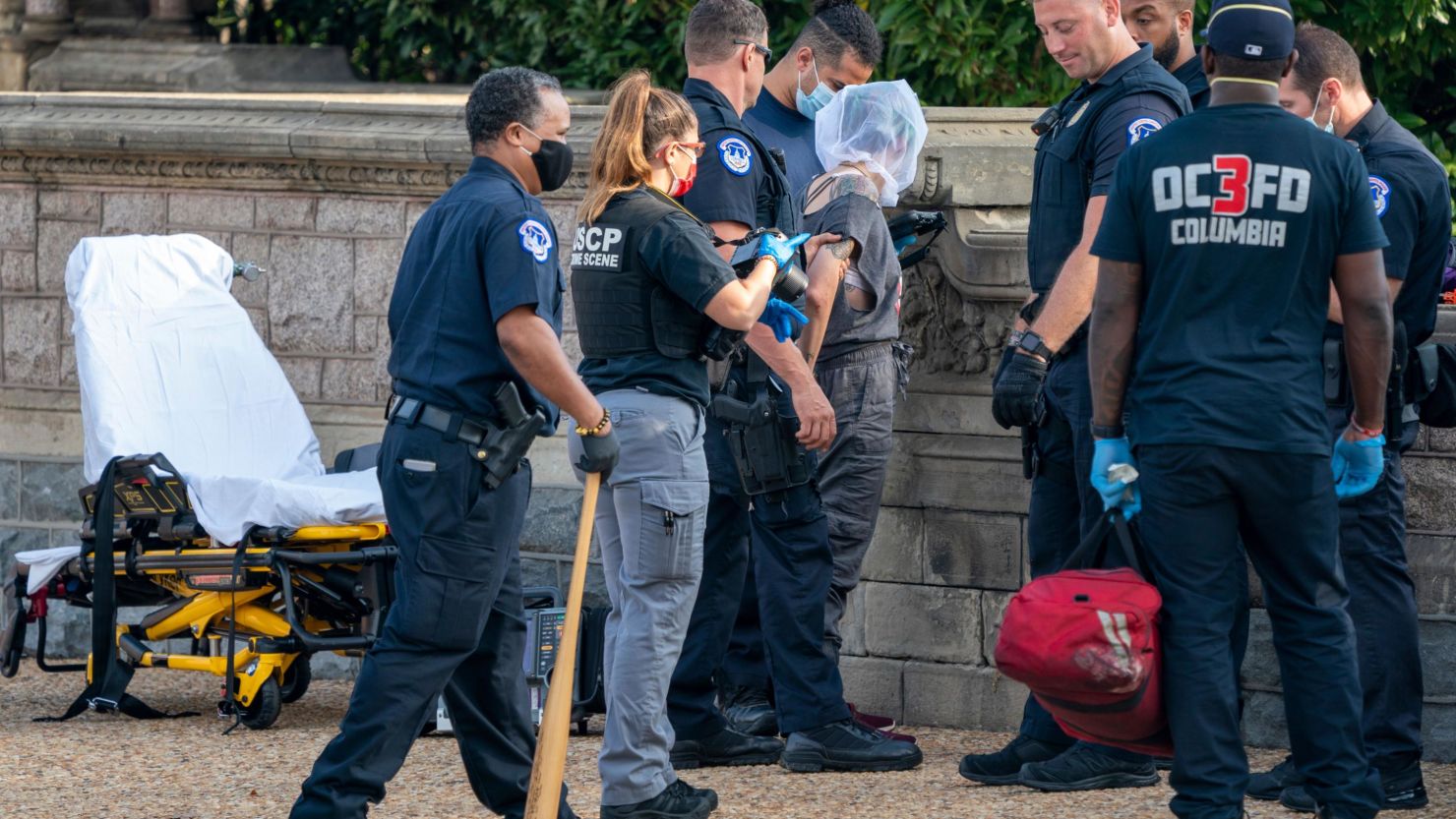 A protester is arrested following a reported attack on a Capitol police officer on the West Front of the US Capitol in Washington, on October 15, 2021. The arrest was prior to the Build Back Fossil Free march to the US Capitol that is calling on President Joe Biden to declare a climate emergency and stop all new fossil fuel projects. 