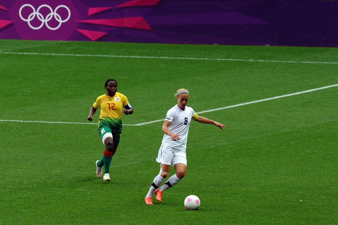 Smith is challenged by Cameroon's midfielder Francoise Bella during the London 2012 Olympics. 