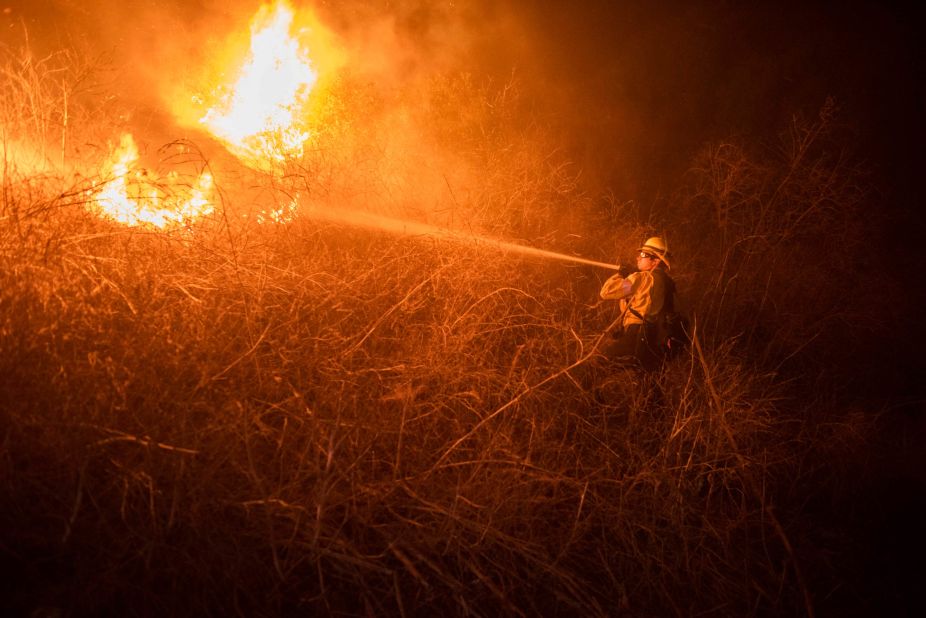 Firefighter Tyler McManigal battles the Alisal Fire in Gaviota, California, on October 12.