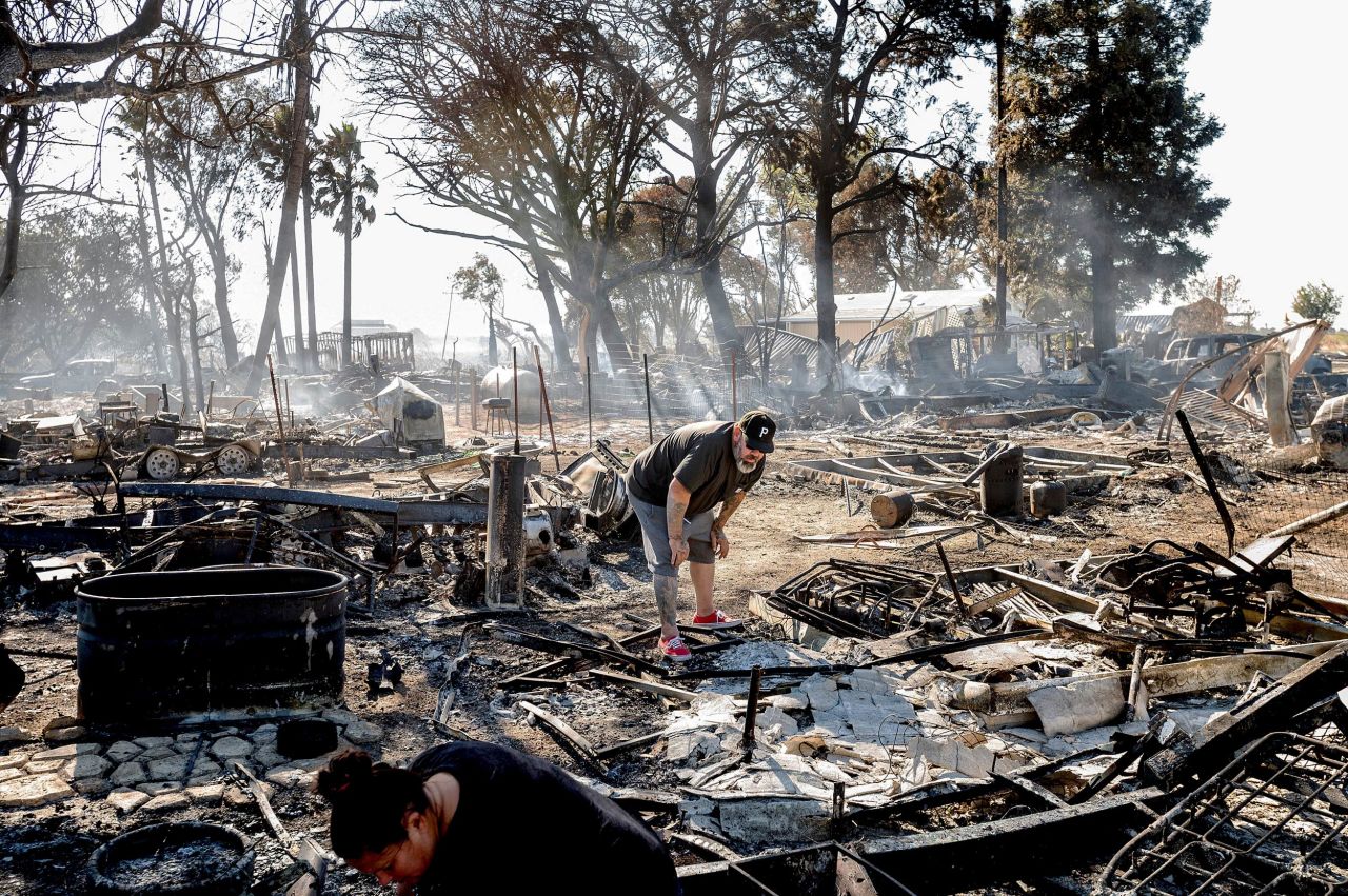 James Grooms looks through the remains of his home at the Rancho Marina Mobile Home & RV Park following the Brannan Fire in Sacramento County, California, on Tuesday, October 12. 