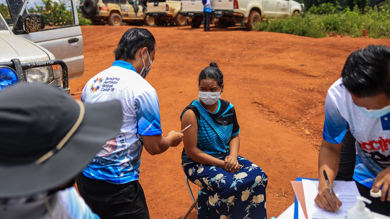 A woman receives a dose of the Pfizer vaccine on October 5, 2021 in the district of Gua Musang, Kelantan, Malaysia.