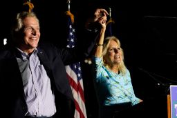 First lady Jill Biden laughs with Democratic gubernatorial candidate Terry McAuliffe during a rally in Richmond, Virginia, on October 15, 2021. 