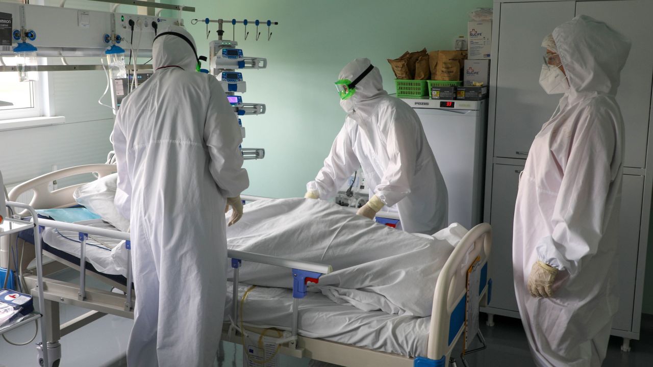 Healthcare workers and a patient are seen in an intensive care unit at the Kalachevskaya Central District Hospital in Russia's Volgograd region on October 12, 2021.