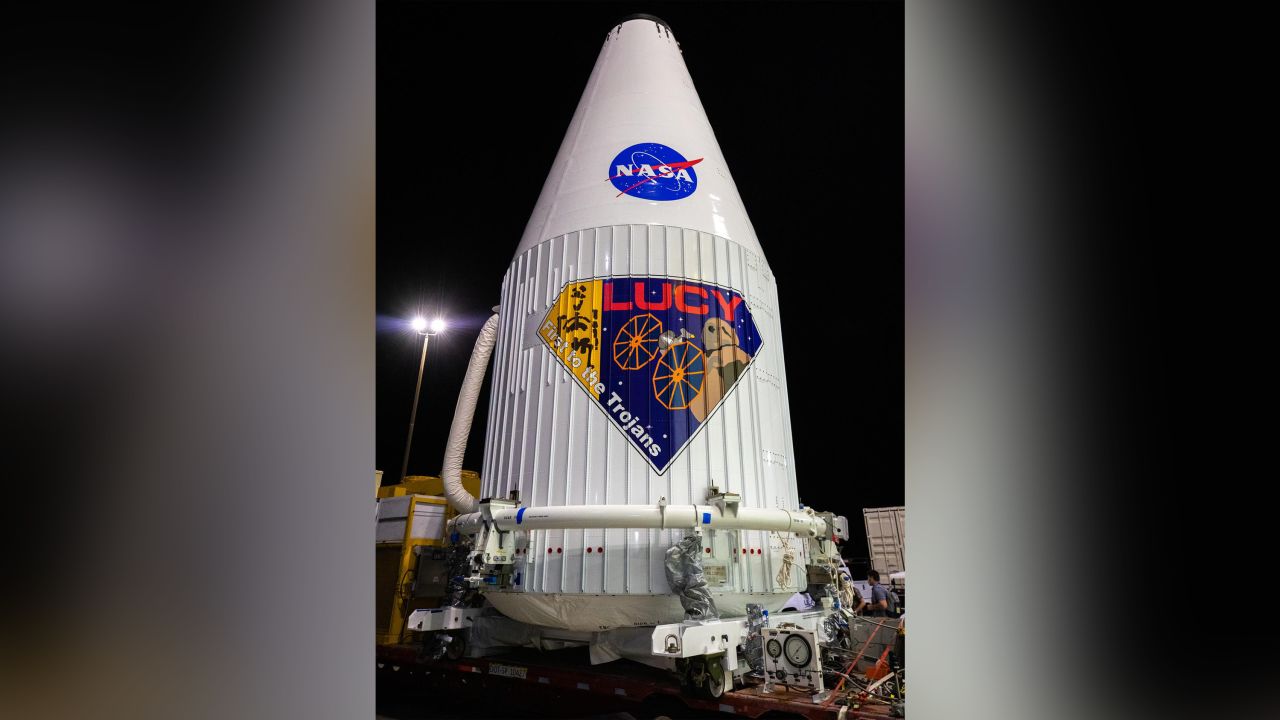 The Lucy mission logo is shaped like a diamond and includes artwork depicting the Lucy fossil.