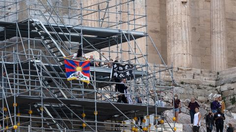 Protesters raise a Tibetan flag and a banner from scaffolding at the Acropolis hill, in Athens, Greece, on Sunday, October 17.