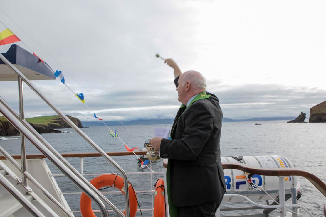 Dingle parish priest Michael Moynihan blesses the boat and its passengers with holy water.