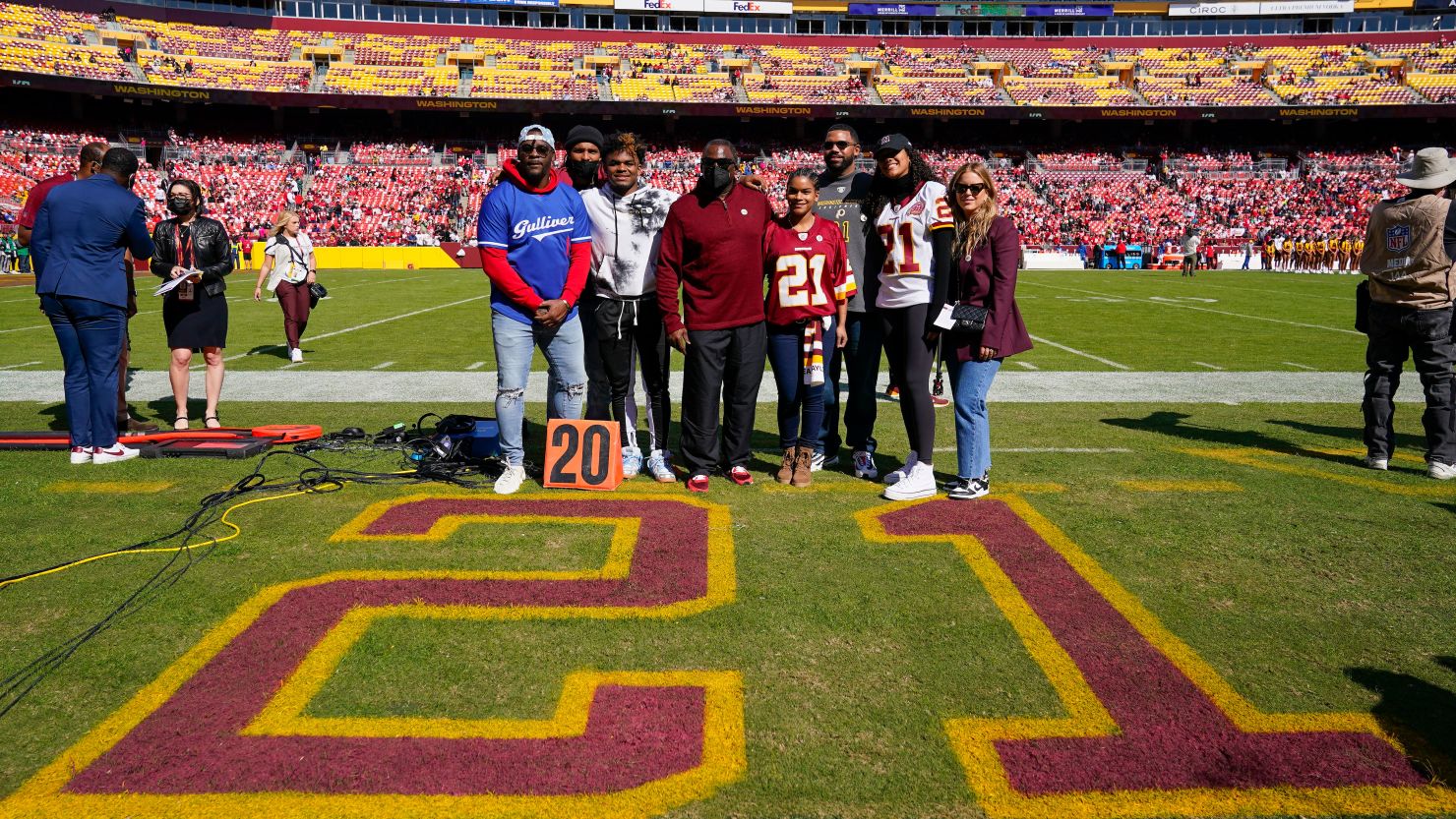 Members of the late Sean Taylor's family gather on the field as the Washington Football Team retire his number during a ceremony before the start of an NFL football game against the Kansas City Chiefs, Sunday, Oct. 17, 2021, in Landover, Md.