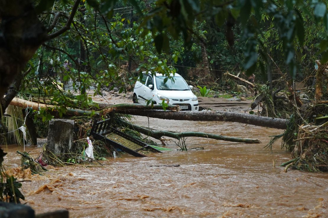 A car is stuck in muddy water after torrential rain in Kerala state on October 16.