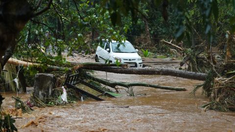 A car is stuck in muddy water after torrential rain in Kerala state on October 16.