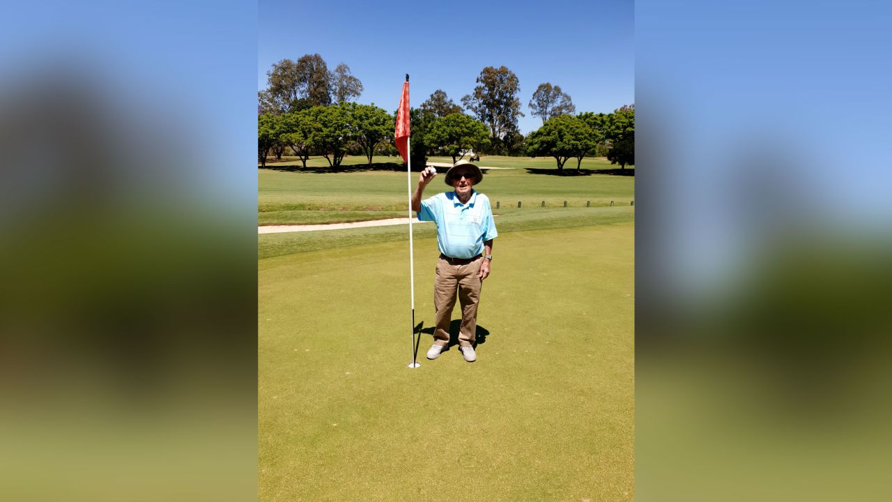 A photo posted on the Indooroopilly Golf Club Facebook page shows 99-year-old Hugh Brown holding up his golf ball next to the fifth hole.