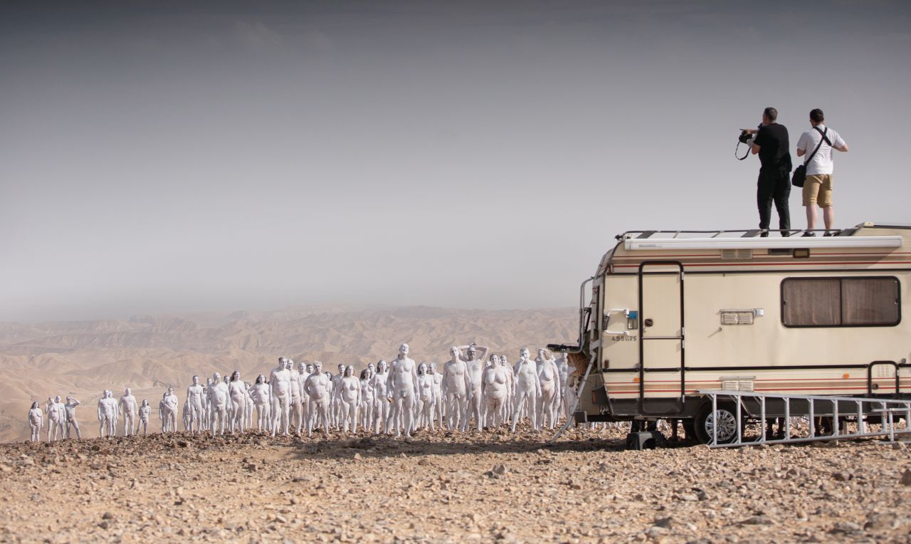 Tunick directs participants from atop a camper van.