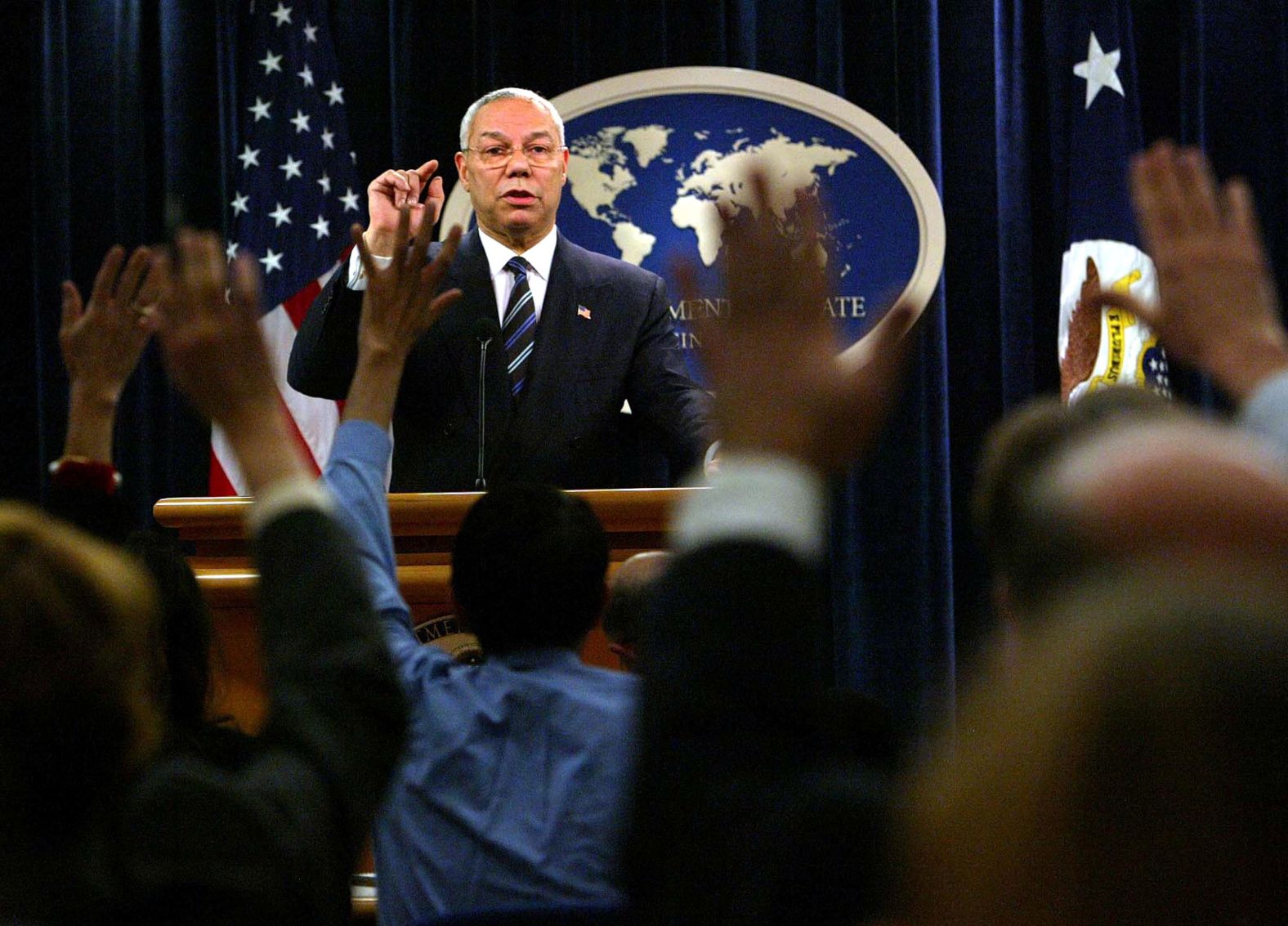 Powell takes reporters' questions during a 2004 news conference at the State Department.