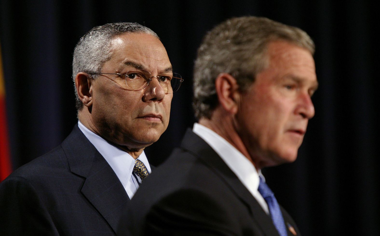 Powell stands with Bush before the President signed a $15 billion global AIDS bill in 2003.