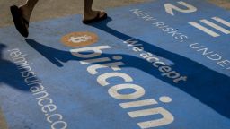 An attendee walk past Bitcoin signage during the Bitcoin 2021 conference in Miami, on June 5, 2021.