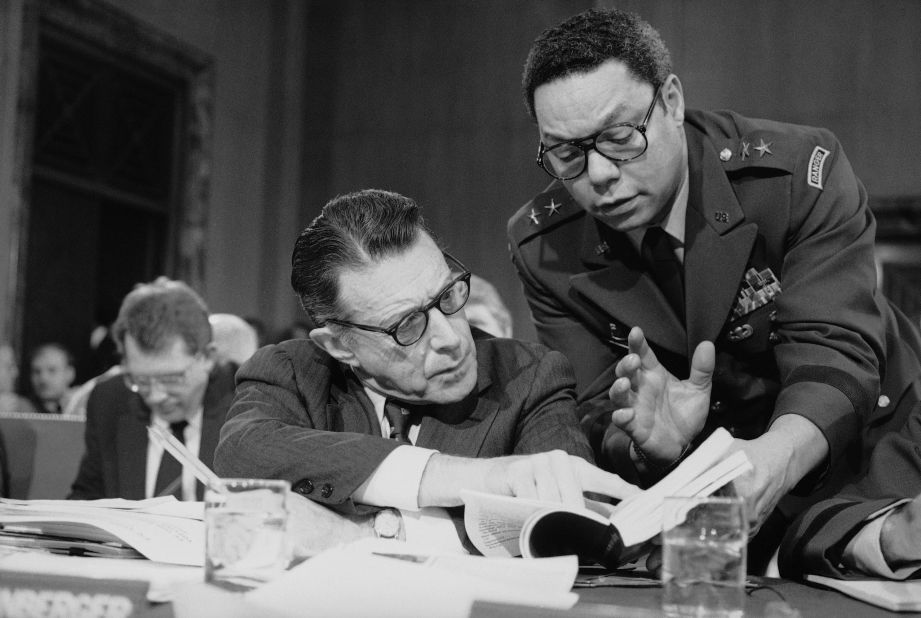 Powell confers with US Defense Secretary Casper Weinberger during a Senate committee meeting in Washington in 1985. Powell stayed in the Army after returning home from Vietnam, attending the National War College and rising in leadership. He was promoted to brigadier general in 1979, and he became a senior military assistant to Weinberger in 1983.