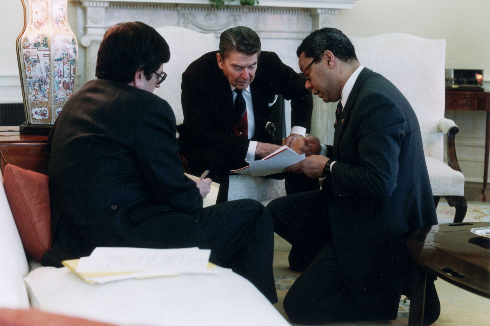 Powell advises Reagan in 1988 during an Oval Office meeting of the National Security Council.