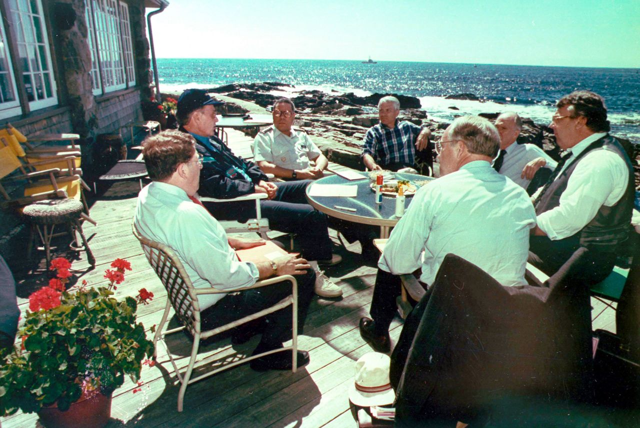Powell joins President George H.W. Bush and other key advisers at the President's summer home near Kennebunkport, Maine, in 1990. Bush is on the left in the blue hat.