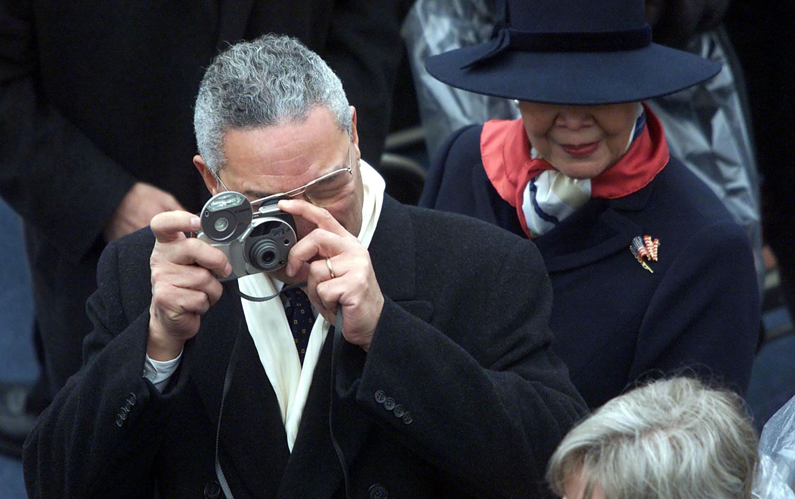 Powell takes photos beside his wife, Alma, at Bush's inauguration in 2001.