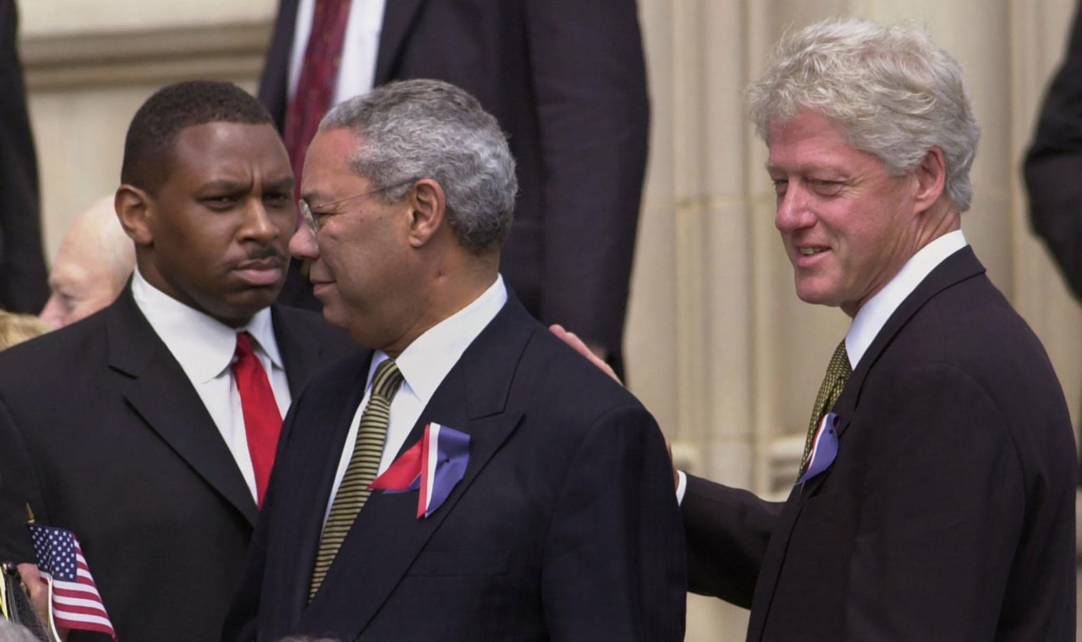 Former President Bill Clinton pats Powell's back as they depart the Washington National Cathedral in 2001. They were there on the National Day of Prayer and Remembrance, honoring those who died in the September 11 terrorist attacks.