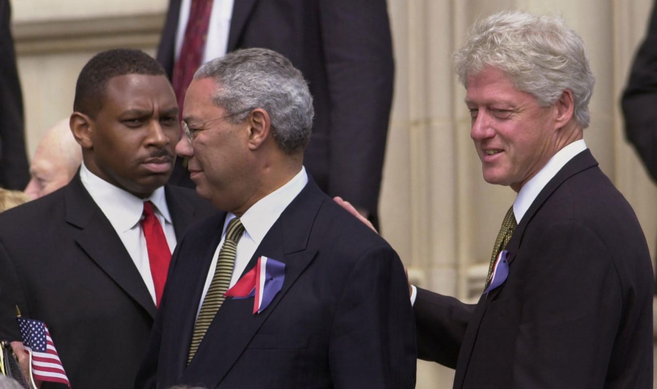 Former President Bill Clinton pats Powell's back as they depart the Washington National Cathedral in 2001. They were there on the National Day of Prayer and Remembrance, honoring those who died in the September 11 terrorist attacks.