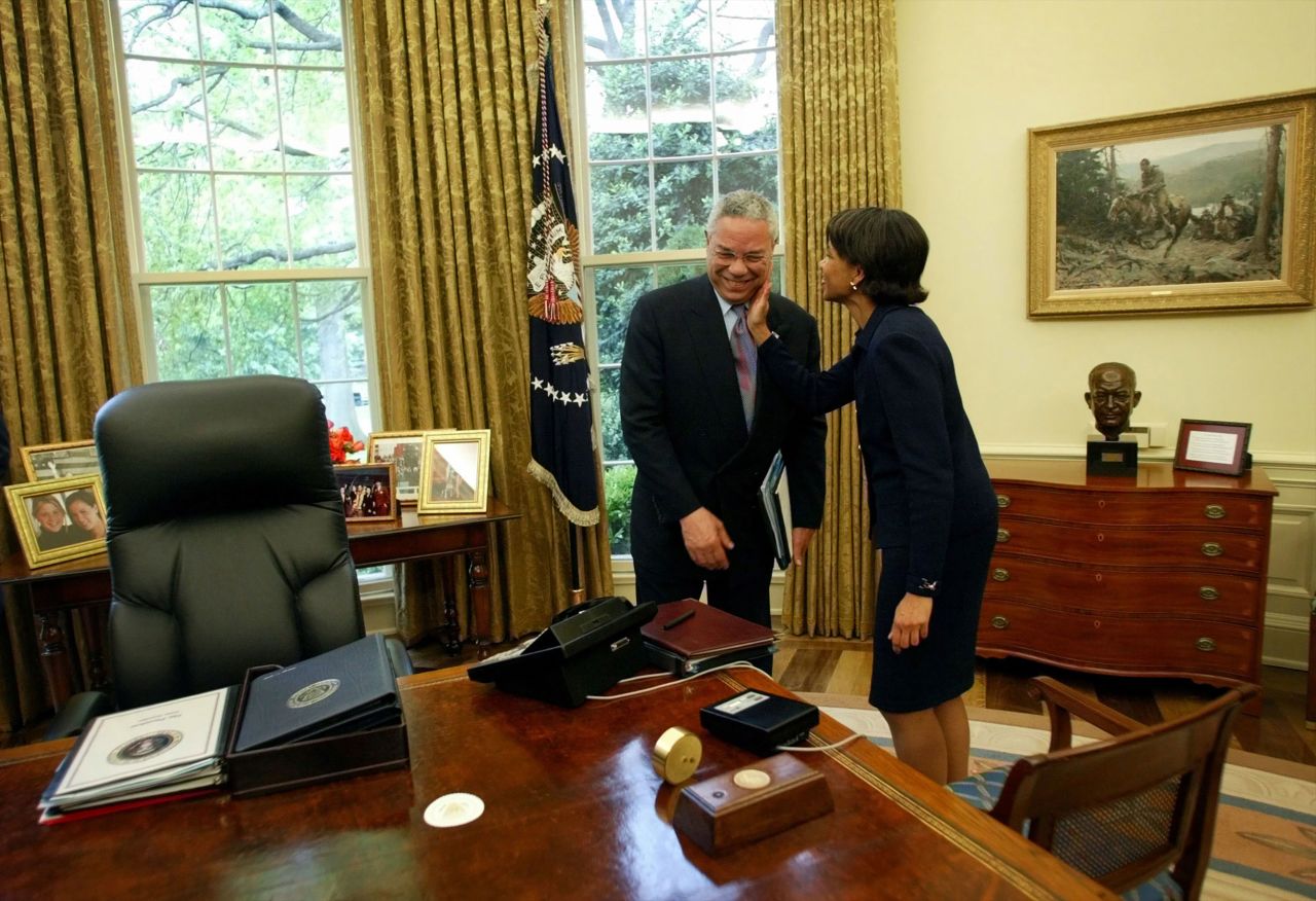 Powell receives a pat on the cheek from national security adviser Condoleezza Rice during an Oval Office meeting in 2002. In 2005, Rice would succeed Powell as secretary of state.