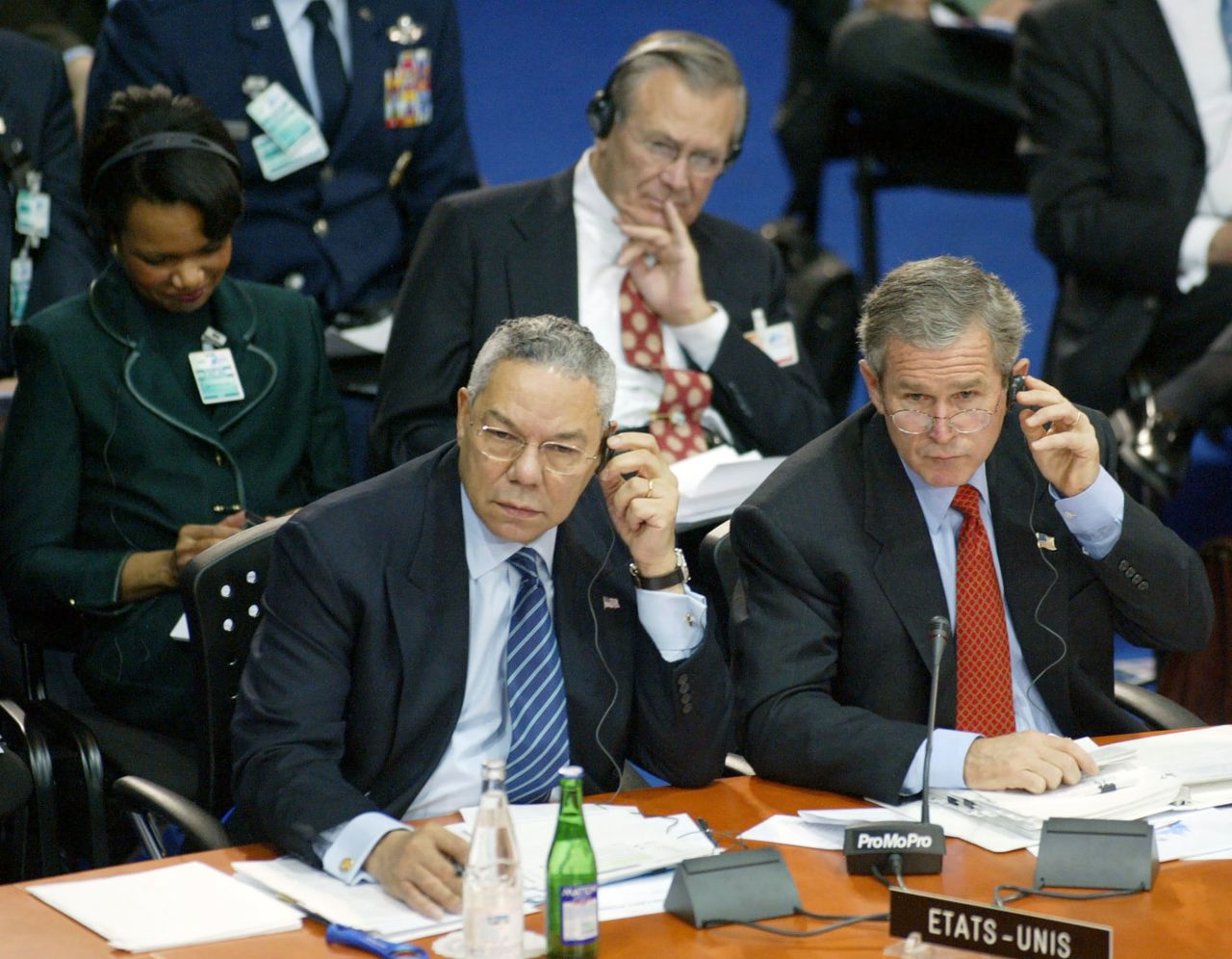 Powell and Bush attend a NATO summit in Prague, Czech Republic, in 2002. Behind them are Rice and Rumsfeld.