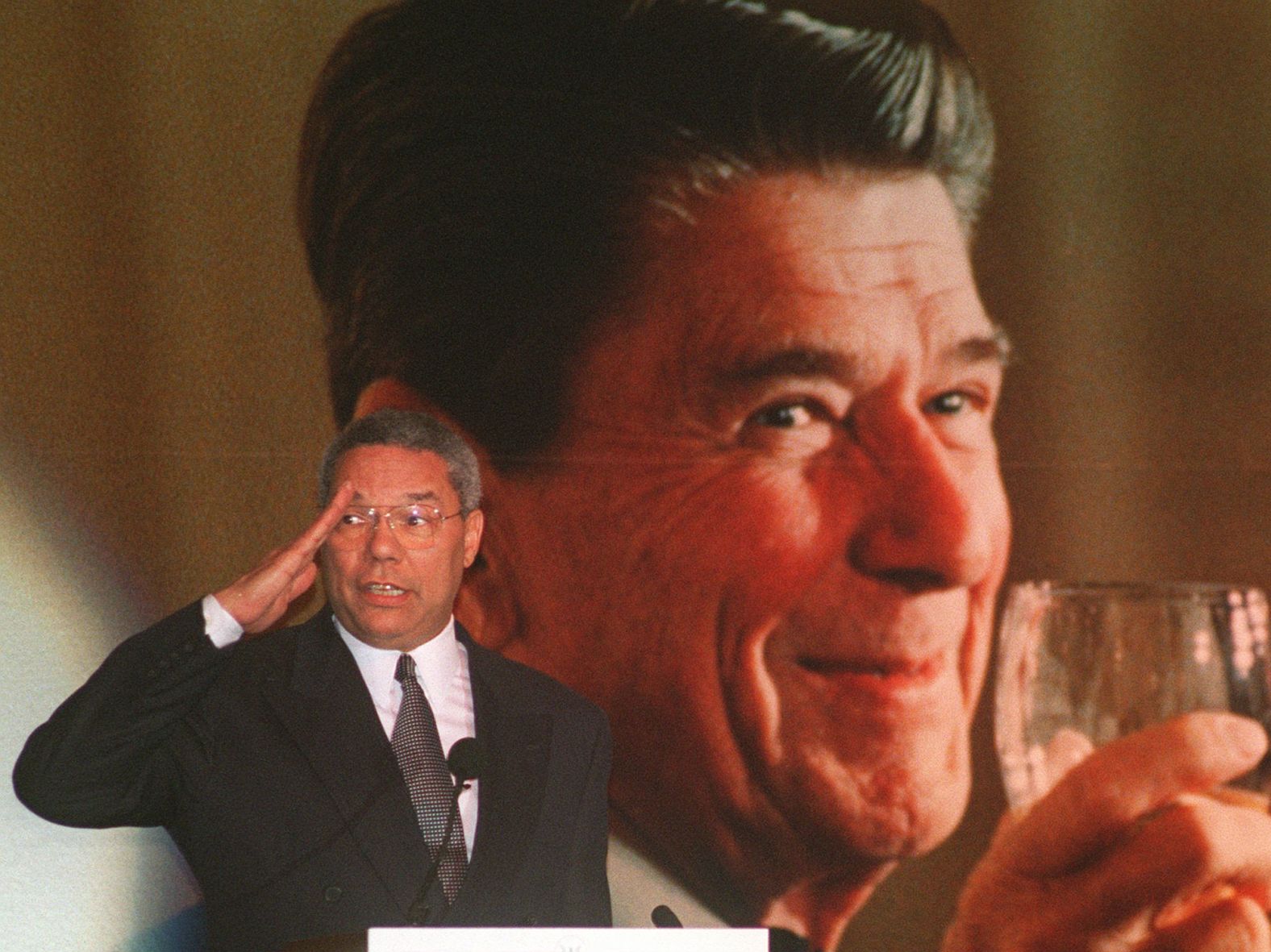 Powell salutes as he tells a story about himself and former President Ronald Reagan in 1996. He was attending Reagan's 85th birthday celebration at a restaurant in West Hollywood, California.