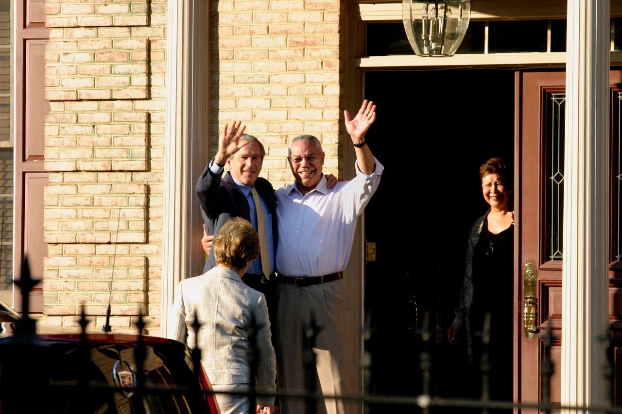 Bush and Powell wave from Powell's home in McLean, Virginia, in 2005.