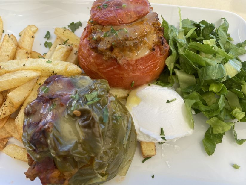 In Greece, dolmades can be much more than tiny rolls of grape leaves stuffed with a vegetable rice mixture. Green peppers and tomatoes are frequently used, served with yogurt and the traditional fries.